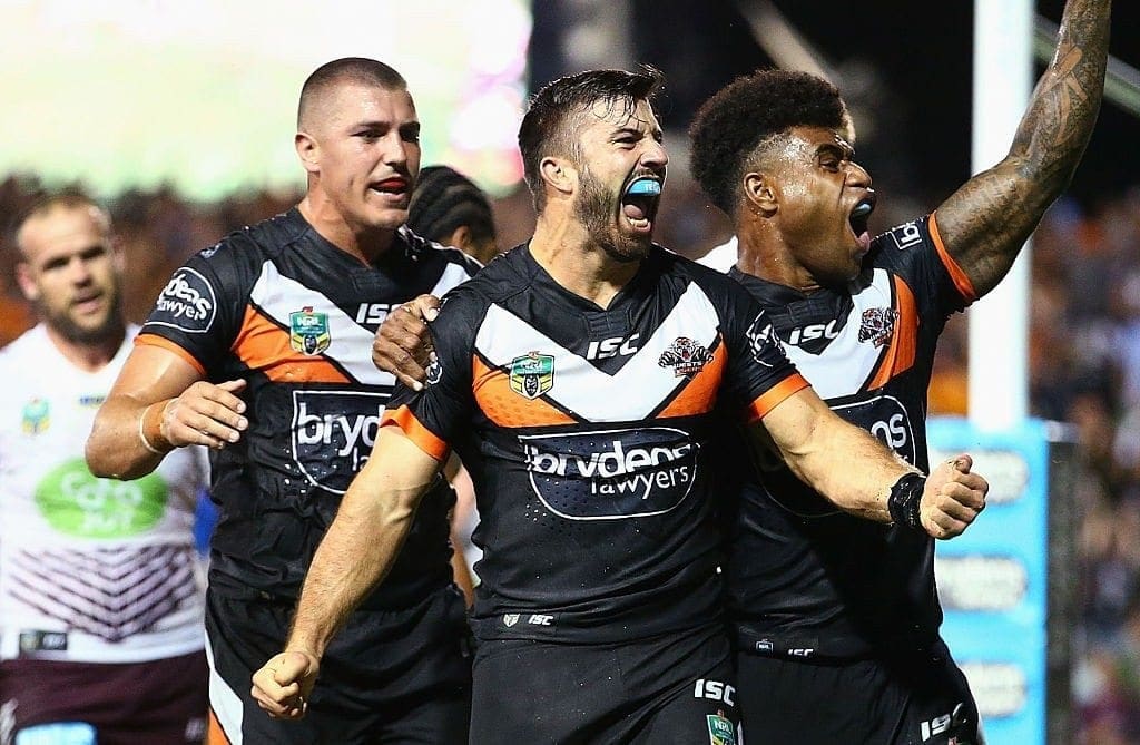 SYDNEY, AUSTRALIA - MARCH 14: James Tedesco of the Tigers celebrates his third try with team mates during the round two NRL match between the Wests Tigers and the Manly Sea Eagles at Leichhardt Oval on March 14, 2016 in Sydney, Australia. (Photo by Mark Nolan/Getty Images)