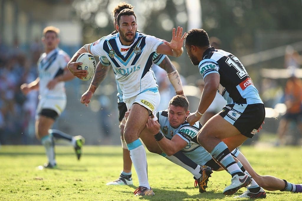 SYDNEY, AUSTRALIA - APRIL 10: Ryan James of the Titans is tackled during the round six NRL match between the Cronulla Sharks and the Gold Coast Titans at Southern Cross Group Stadium on April 10, 2016 in Sydney, Australia. (Photo by Mark Kolbe/Getty Images)